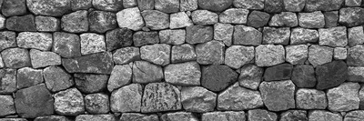 A dry-stone wall built from irregularly shaped rocks fitted tightly together, standing in for this week's theme of many small units — token vectors, skill catalogs — that only hold up when the structure connecting them is sound